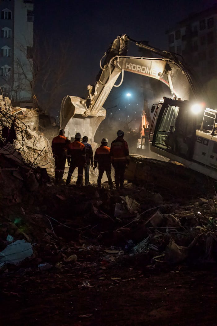Rescue workers inspect earthquake debris at night in Kahramanmaraş, Türkiye.
